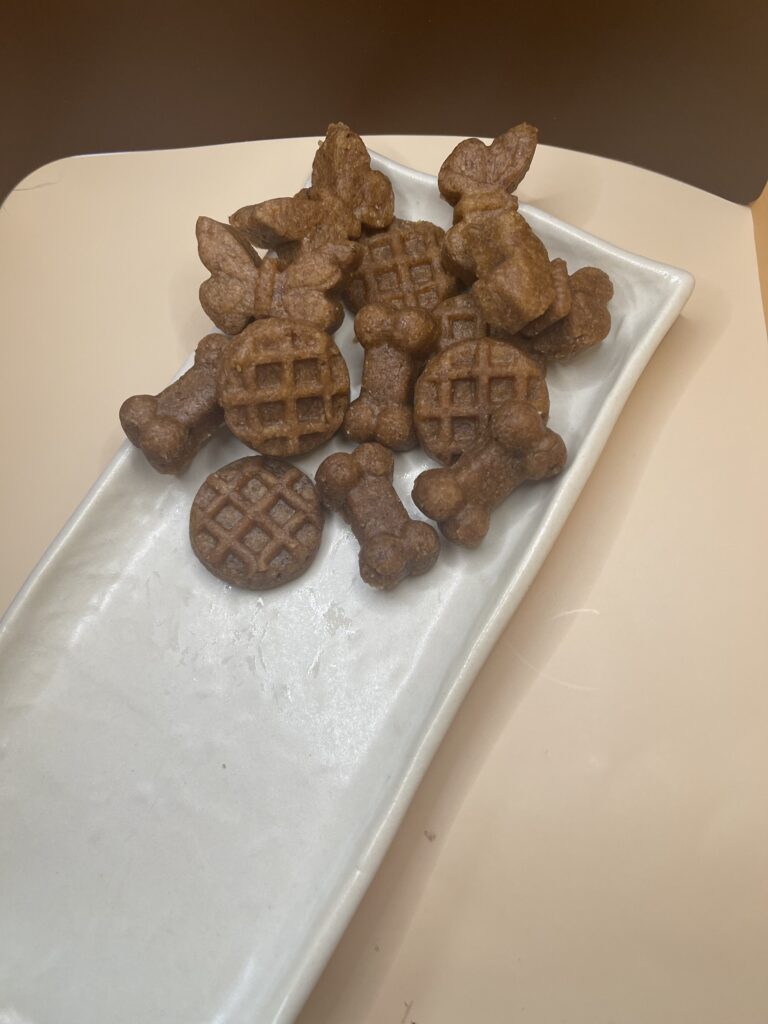 A Plate Filled with Assorted Dog Treats Placed on a Wooden Table