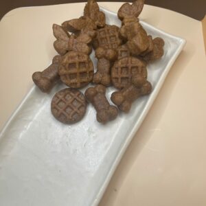 A Plate Filled with Assorted Dog Treats Placed on a Wooden Table